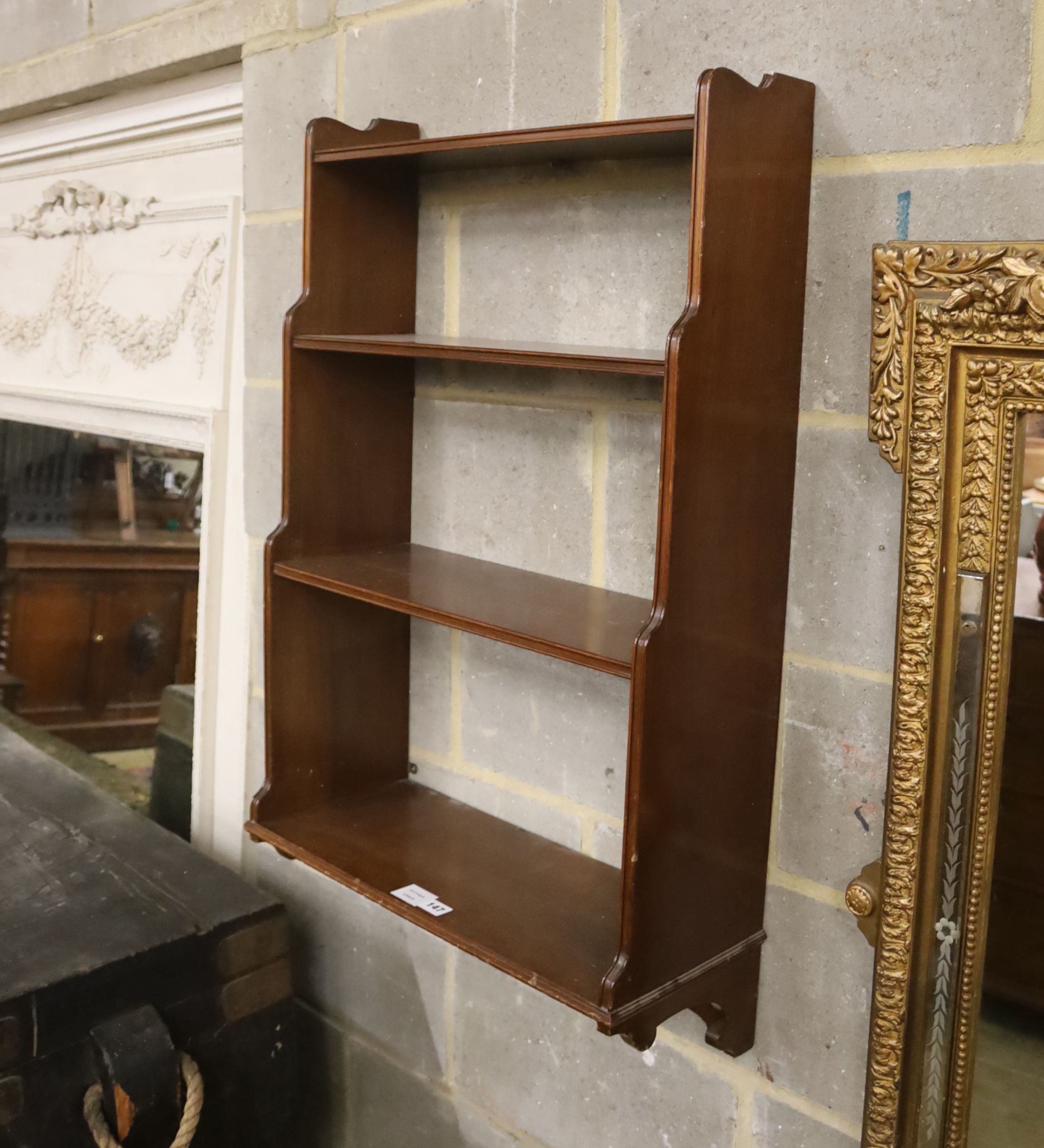 A mahogany three shelf wall bracket, width 57cm, depth 23cm, height 94cm